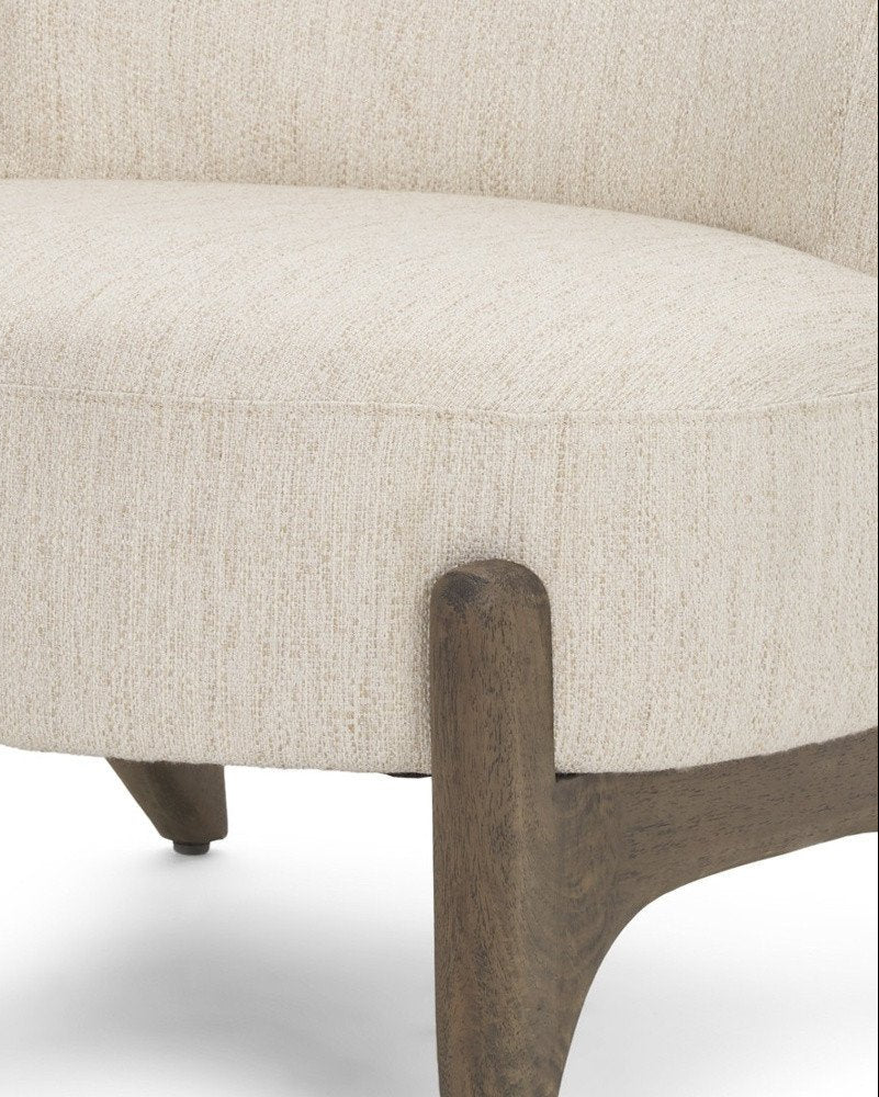 Close-up of a beige upholstered chair with wooden legs on a white background