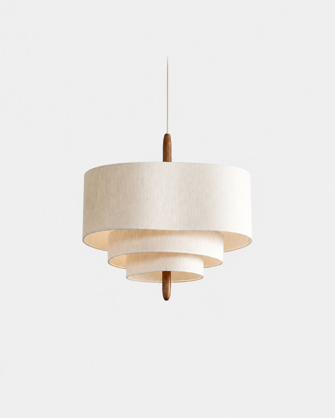 A modern tiered drum pendant light with a textured off-white fabric shade and a central wooden accent, suspended against a plain light gray background.